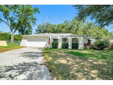 Charming single-story home with a well-maintained lawn and a classic white exterior at 135 Rodney Ct, Palm Harbor, FL 34684