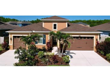 Charming single-Gathering home boasting a well-manicured front yard and a welcoming facade with a three car garage at 1723 Whitewillow Dr, Wesley Chapel, FL 33543
