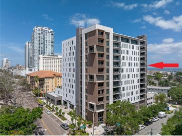 Modern condo building featuring a mix of white and brown panels with private balconies in an urban setting at 199 Dali Blvd # 902, St Petersburg, FL 33701