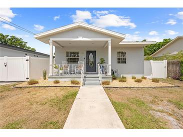 Charming single-story home with a covered front porch, neat landscaping, and a walkway leading to the entrance at 212 N Bradford Ave, Tampa, FL 33609