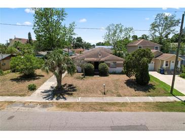 Charming single-story home featuring a quaint front yard with mature trees and a classic design at 3016 W Palmetto St, Tampa, FL 33607