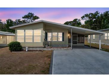 Charming single-story home featuring a covered carport and well-maintained landscaping at 4801 Blanco Dr, Zephyrhills, FL 33541