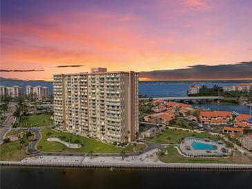 Stunning sunset view of the high-rise condo overlooking the bay and community pool at 4900 Brittany S Dr # 808, St Petersburg, FL 33715