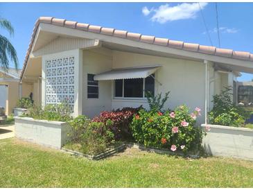 Cozy single-story home featuring a tile roof and pretty landscaping in the front yard at 5105 Bonito Dr, New Port Richey, FL 34652