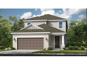 Charming two-story home with a large garage, well-manicured lawn and appealing architectural details at 841 Steel Dr, Apollo Beach, FL 33572