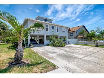 Charming stilt home with large driveway and lush tropical landscaping in desirable location at 13974 75Th Ave, Seminole, FL 33776