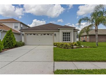 Charming single-story home with a two-car garage, landscaped yard, and neutral exterior at 25830 Crippen Dr, Land O Lakes, FL 34639