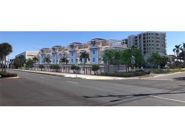 Street view highlighting attractive architecture, mature trees, and overall curb appeal at 20 Outlook Way Blvd # 7, Dunedin, FL 34698