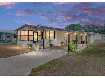Charming single-story home with a covered parking area, inviting curb appeal, and a cozy front porch at 35051 Colony Hills Dr, Zephyrhills, FL 33541