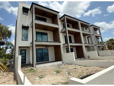 Modern three-story condo featuring covered balconies, sleek design, and a contemporary aesthetic at 501 W Ross Ave # 2, Tampa, FL 33602