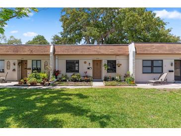 Charming townhome featuring a well-maintained lawn and beautiful landscaping at 1278 Mission Cir # 45B, Clearwater, FL 33759