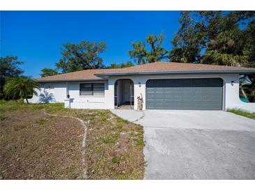Charming single-story home with a two-car garage and a well-maintained front lawn at 2167 Corfell St, Port Charlotte, FL 33948