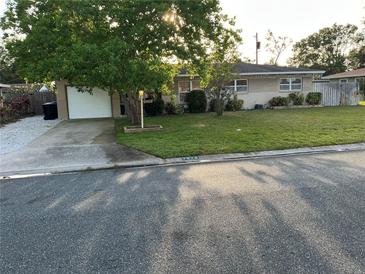 Charming single-story home featuring a lush front yard and a one-car garage at 7076 17Th N St, St Petersburg, FL 33702
