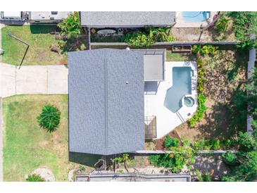 Aerial view of home with a pool, spa, patio, driveway, and landscaping at 320 Crosswinds Dr, Palm Harbor, FL 34683
