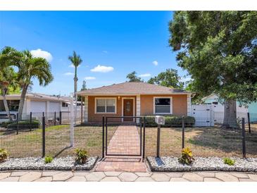 A charming fenced-in home with a well-maintained lawn and front garden at 5324 3Rd N Ave, St Petersburg, FL 33710