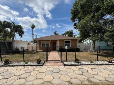 Charming home featuring a landscaped front yard with a brick walkway leading to the front door at 5324 3Rd N Ave, St Petersburg, FL 33710