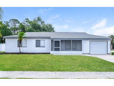 Charming single-story home features a well-maintained lawn, attached garage, and neutral color scheme at 5670 Postma St, North Port, FL 34287