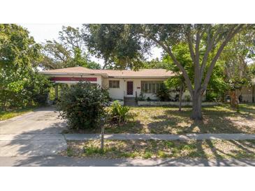 Charming single-story home featuring a well-maintained lawn and mature landscaping at 111 Orangeview Ave, Clearwater, FL 33755