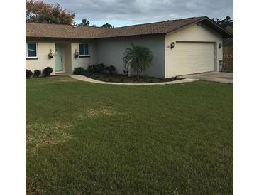 Charming single-story home featuring a well-maintained lawn and inviting curb appeal at 3115 Winchester Dr, Dunedin, FL 34698