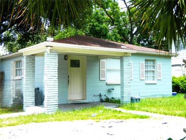 Charming single-story home with a covered porch, light blue exterior, and white trim at 3502 E 33Rd Ave, Tampa, FL 33610
