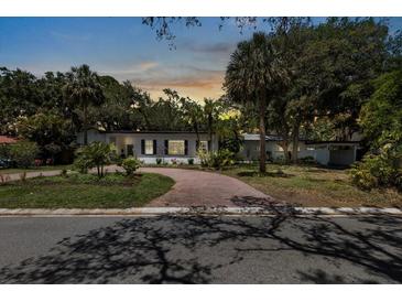 Charming single-story home featuring a brick driveway and lush landscaping at 8239 26Th N Ave, St Petersburg, FL 33710