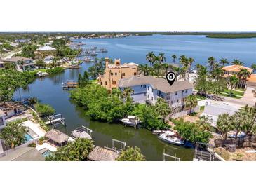 Stunning waterfront property with private boat docks and lush landscaping in a tropical setting at 1811 Bayou Grande Ne Blvd, St Petersburg, FL 33703