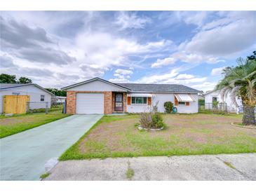 Charming single-story home with a brick facade, one-car garage, and well-maintained front yard at 39423 9Th Ave, Zephyrhills, FL 33542