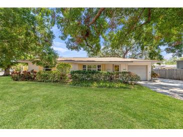 Charming single-story home with a well-manicured lawn and mature trees offering shade and curb appeal at 4465 1St Ne Way, St Petersburg, FL 33703
