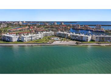 Stunning aerial view of beachfront condos, showcasing the turquoise waters and lush landscaping at 6021 Bahia Del Mar Cir # 238, St Petersburg, FL 33715