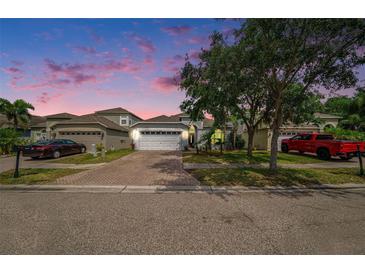 Charming single-story home featuring a brick driveway, two car garage, and well-maintained landscaping at 8407 Hunters Fork Loop, Ruskin, FL 33573