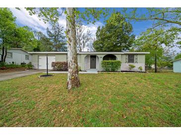 Charming single-story home featuring a well-maintained lawn and inviting front entrance at 9613 River Rd, Spring Hill, FL 34608