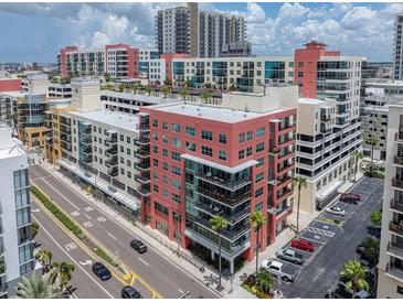 Multi-story condo building with glass balconies located in an urban setting with palm trees and street views at 1208 E Kennedy Blvd # 914, Tampa, FL 33602