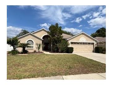 Charming single-story home with mature landscaping and a two-car garage at 2213 Towering Oaks Cir, Seffner, FL 33584