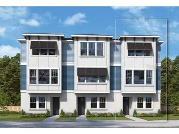 Modern townhome featuring a stylish exterior with clean lines, neutral colors, and black window accents at 6605 N Nebraska Ave # 6, Tampa, FL 33604