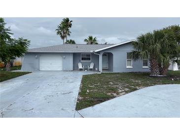 Charming single-story home with a well-maintained front yard and attached garage, exuding curb appeal at 10208 Oak Hill Dr, Port Richey, FL 34668