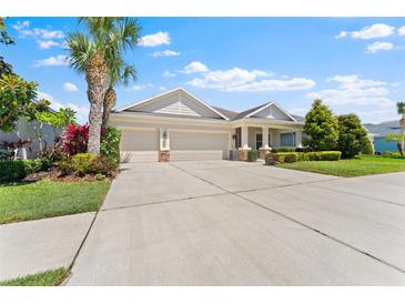 Charming single-story home with a three-car garage and well-manicured landscaping at 17731 Bright Wheat Dr, Lithia, FL 33547