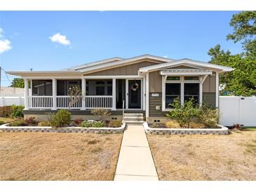 Charming home with a welcoming porch, landscaped front yard, and walkway leading to the front door at 2715 9Th N Ave, St Petersburg, FL 33713