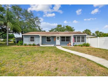 Charming single-story home featuring a well-manicured lawn and inviting walkway leading to a white front door at 4403 W Bay Court Ave, Tampa, FL 33611