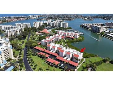 Beautiful aerial view of waterfront condos with boat docks and lush landscaping in desirable location at 7867 Sailboat Key S Blvd # 101, South Pasadena, FL 33707