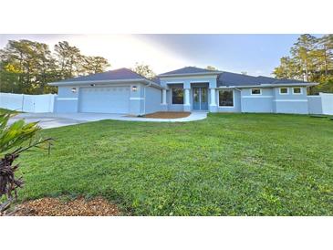 Beautiful single-story home with a well-manicured lawn and attached two-car garage at 11240 Marvelwood, Brooksville, FL 34614