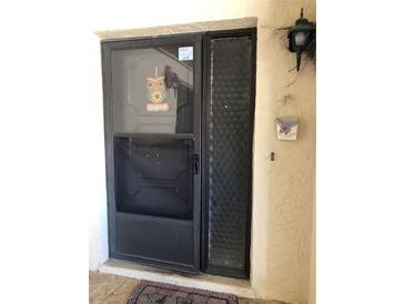 A welcoming front door with secure screen and adjacent textured privacy window at 1503 12Th Se Ct # 1503, Largo, FL 33771