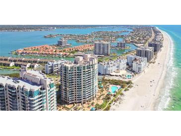 Stunning aerial view of beachfront condos and coastal waterways of Sand Key, Florida at 1560 Gulf Blvd # 306, Clearwater Beach, FL 33767