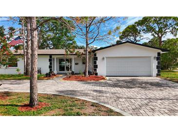 Charming single Gathering home featuring a paver driveway and a well-manicured front yard at 2001 Pinellas Point S Dr, St Petersburg, FL 33712