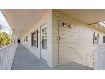 Exterior hallway with unit doors and stairs in a condo community at 2071 Australia W Way # 59, Clearwater, FL 33763