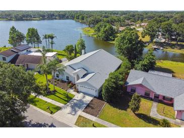 Stunning aerial view of a lakeside home with lush landscaping and a well-maintained yard at 3238 Cullendale Dr, Tampa, FL 33618