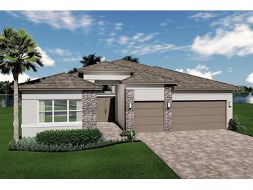 Beautifully rendered single-Gathering home with a stone facade, a large garage, and a well manicured lawn at 3923 Corsica Pl, Wesley Chapel, FL 33543