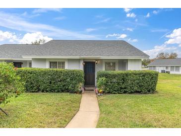 Charming single-story home with a well-manicured lawn and mature landscaping at 12400 Dearborn Dr # F, Hudson, FL 34667