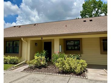 Cozy single story home with a lovely landscaped yard and warm neutral tones offers a welcoming curb appeal at 2567 Oakleaf Ln # 41B, Clearwater, FL 33763