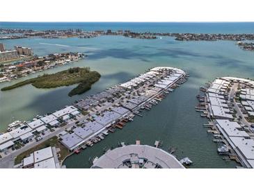 Stunning aerial view of waterfront homes with docks, surrounded by beautiful blue water and distant city skyline at 467 Boca Ciega Point S Blvd, St Petersburg, FL 33708