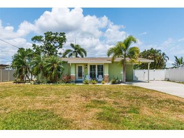 Charming single story home with a well maintained lawn, and a welcoming front porch with white chairs at 4681 Carson Ne St, St Petersburg, FL 33703
